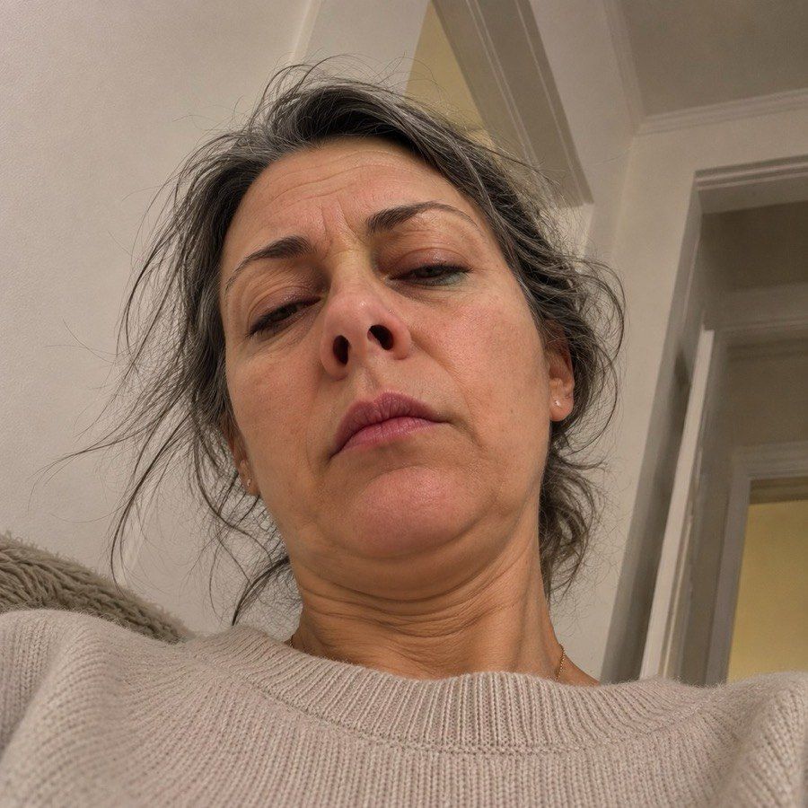 Elena, exhausted — accidental front camera selfie